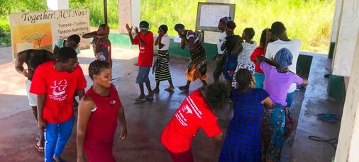Community group dancing and singing about HIV